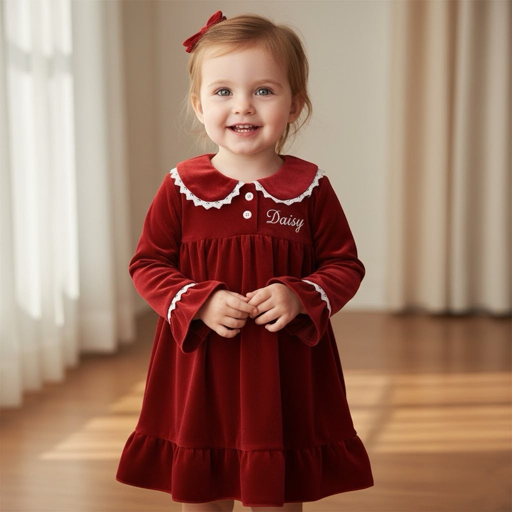 girl wearing red velvet dress with the name daisy on it