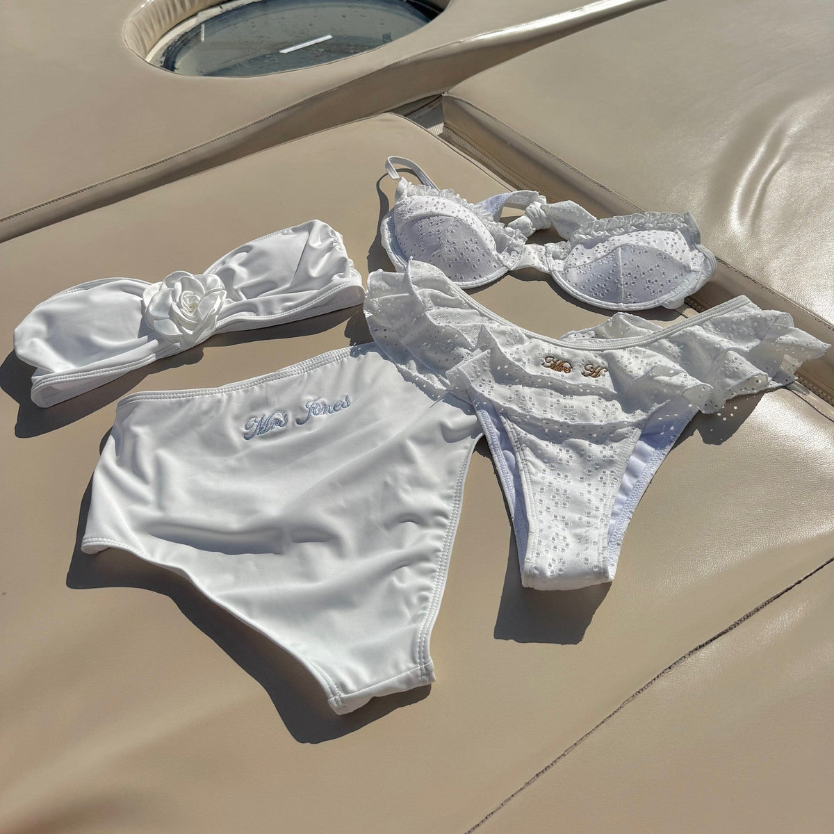 White bikini set on a boat deck with water in the background 
